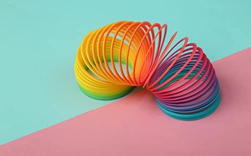 The Dreidel Company colorful plastic spring resting on a flat surface as a return gift option