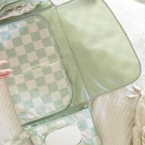 Tiny Twinkle baby changing pad snap loop handle clipped securely onto a stroller handlebar.