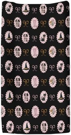 Close up of black cat and witch hat pattern on pink changing pad sheet