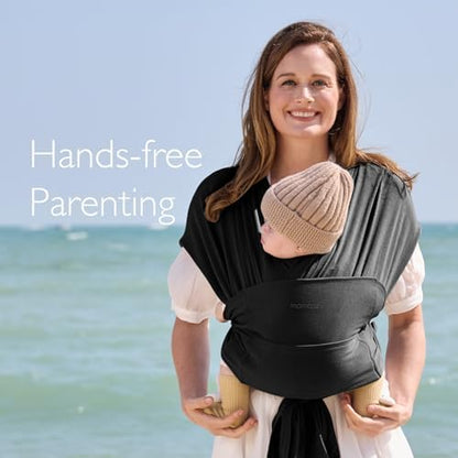 Side view of the black Momcozy baby carrier showing secure hold for a toddler.