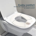 Deeki foldable toddler potty seat hanging by its storage hook next to a bathroom vanity