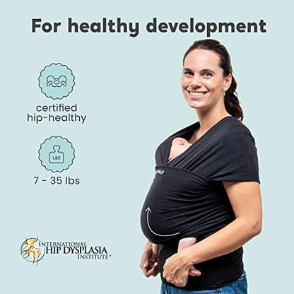 Infant sitting safely inside a CuddleBug baby holder wrap