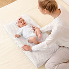 Queness beige baby changing pad cover styled in modern nursery setting