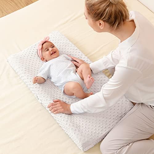 Queness beige baby changing pad cover styled in modern nursery setting