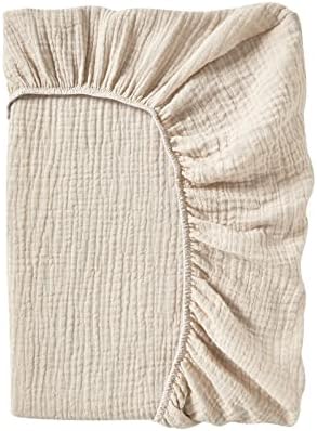 DONOMILO premium baby diaper changing table sheet showcasing the secure elastic borders for standard pads.