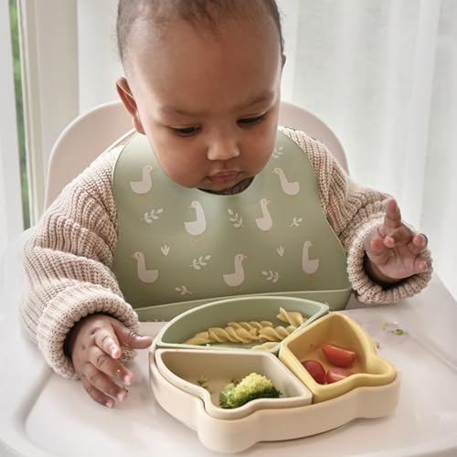 Adjustable neck button closure design on the Little Rawr soft silicone infant bib