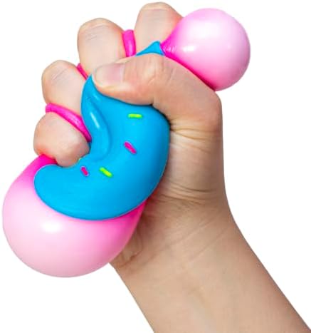 A person holding the squishy Schylling donut toy at an office desk for anxiety management.
