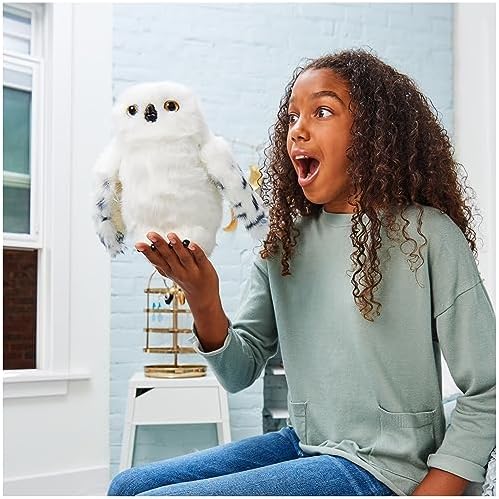 Authentic Hedwig owl toy holding a Hogwarts envelope in her beak for message delivery