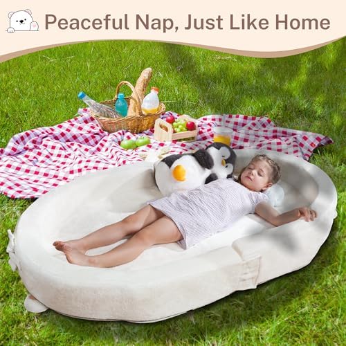 Side angle of the white foldable toddler bed showcasing the thick supportive foam padding.