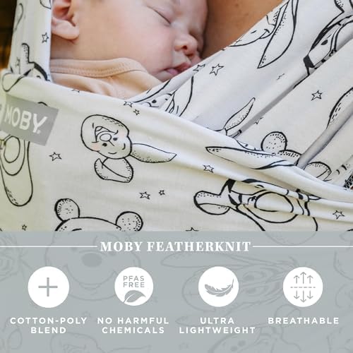 Side profile of an infant securely tucked inside the Moby lightweight wrap carrier