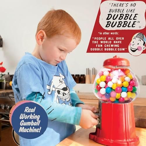 Schylling red gumball machine candy dispenser toy standing on a table with coins nearby