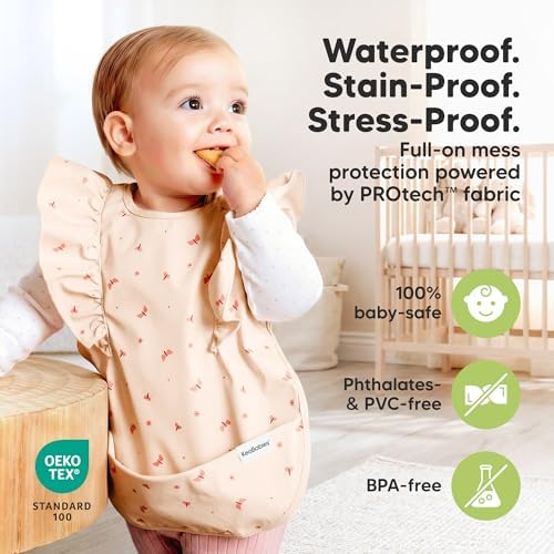 Infant wearing KeaBabies butterfly pattern waterproof feeding bib for self feeding