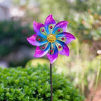Close up of vibrant blue and purple metal petals on garden spinner