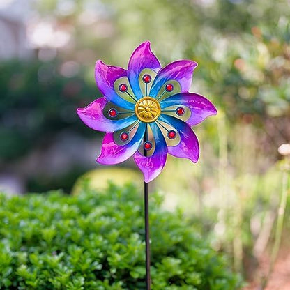 Close up of vibrant blue and purple metal petals on garden spinner