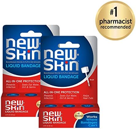 New-Skin waterproof liquid bandage brush applicator tool being pulled from the bottle.