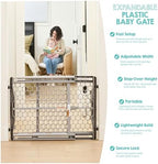 Regalo gray safety gate positioned at the bottom of stairs