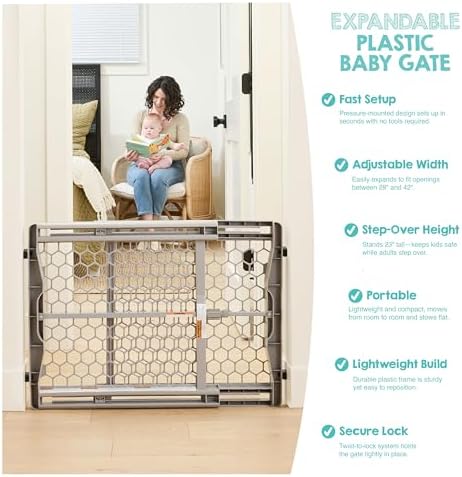 Regalo gray safety gate positioned at the bottom of stairs