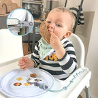 Gelinor first stage baby led weaning accessories pack demonstrating attachment to a toddler stroller bar.
