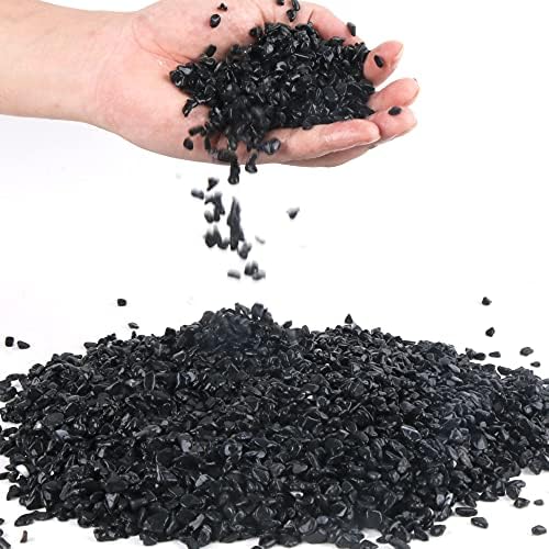 Anothera black decorative pebbles displayed in a glass vase