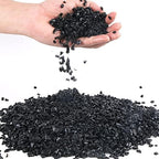 Anothera black decorative pebbles displayed in a glass vase