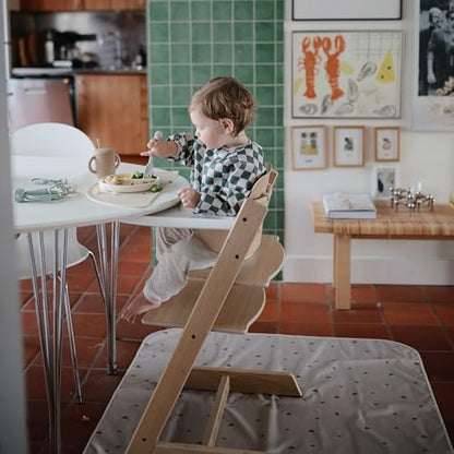 Toddler sitting on the grey Fog color floor mat during arts and crafts