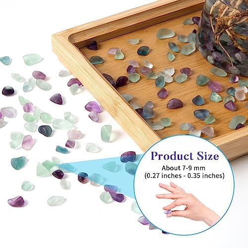 Polished fluorite chips inside a clear glass vase for home decor