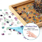 Polished fluorite chips inside a clear glass vase for home decor
