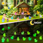 JYXT small resin ducks placed within a miniature outdoor fairy garden landscape.