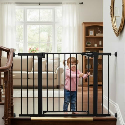Pressure mounted safety gate installation at the bottom of stairs using black wall savers.