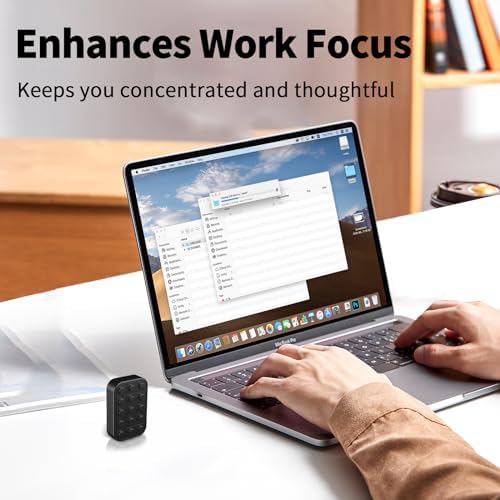 Wshwxy black alloy metal clicker desk gadget sitting next to office stationery on a wooden workspace setup.