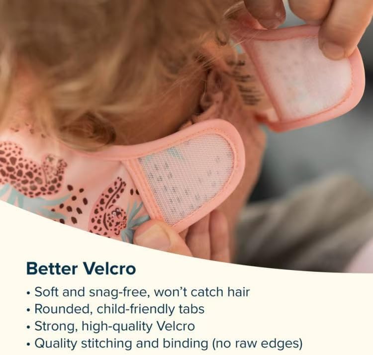 Side perspective of a toddler wearing the waterproof Tiny Twinkle feeding bib during mealtime.