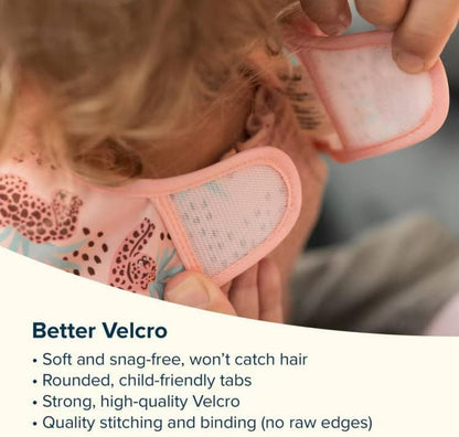 Side perspective of a toddler wearing the waterproof Tiny Twinkle feeding bib during mealtime.