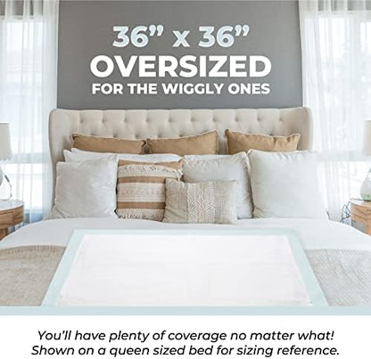 Green Lifestyle chucks pads spread flat on a mattress showing the large thirty-six by thirty-six inch coverage area.