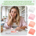 Adult holding the silent pink mechanical button clicker inside an office setting for discreet stress relief.