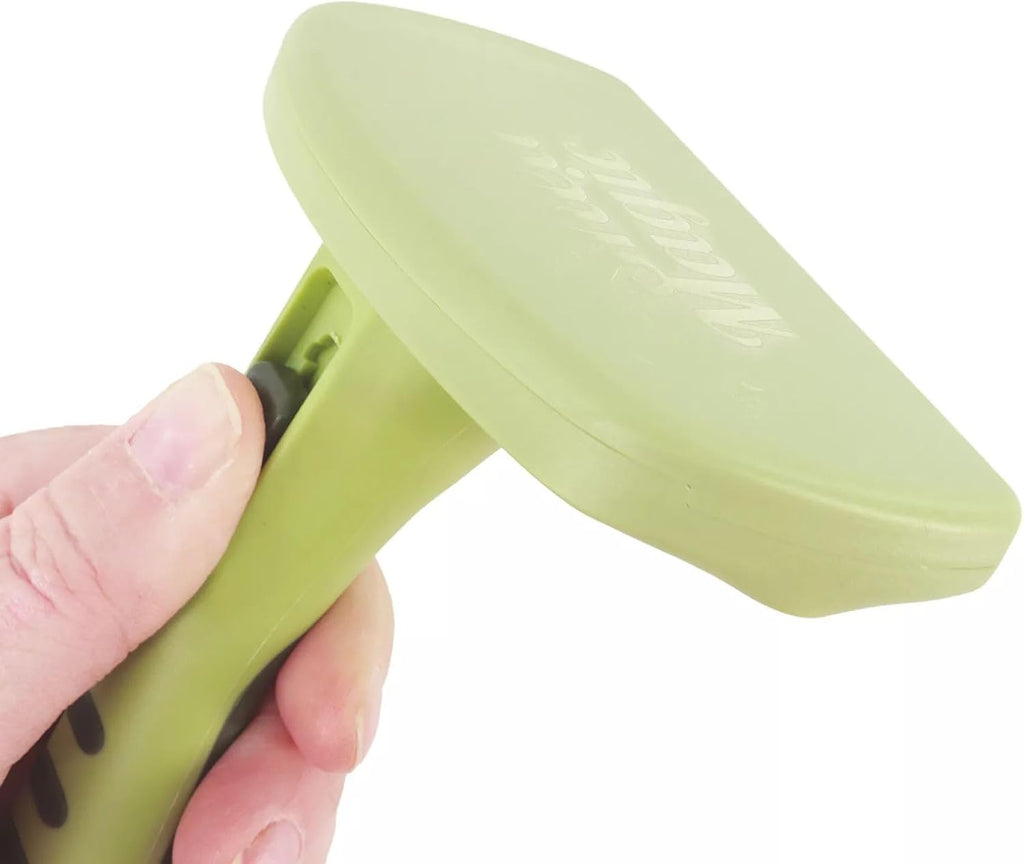 Hand holding Safari self-cleaning cat brush for grooming