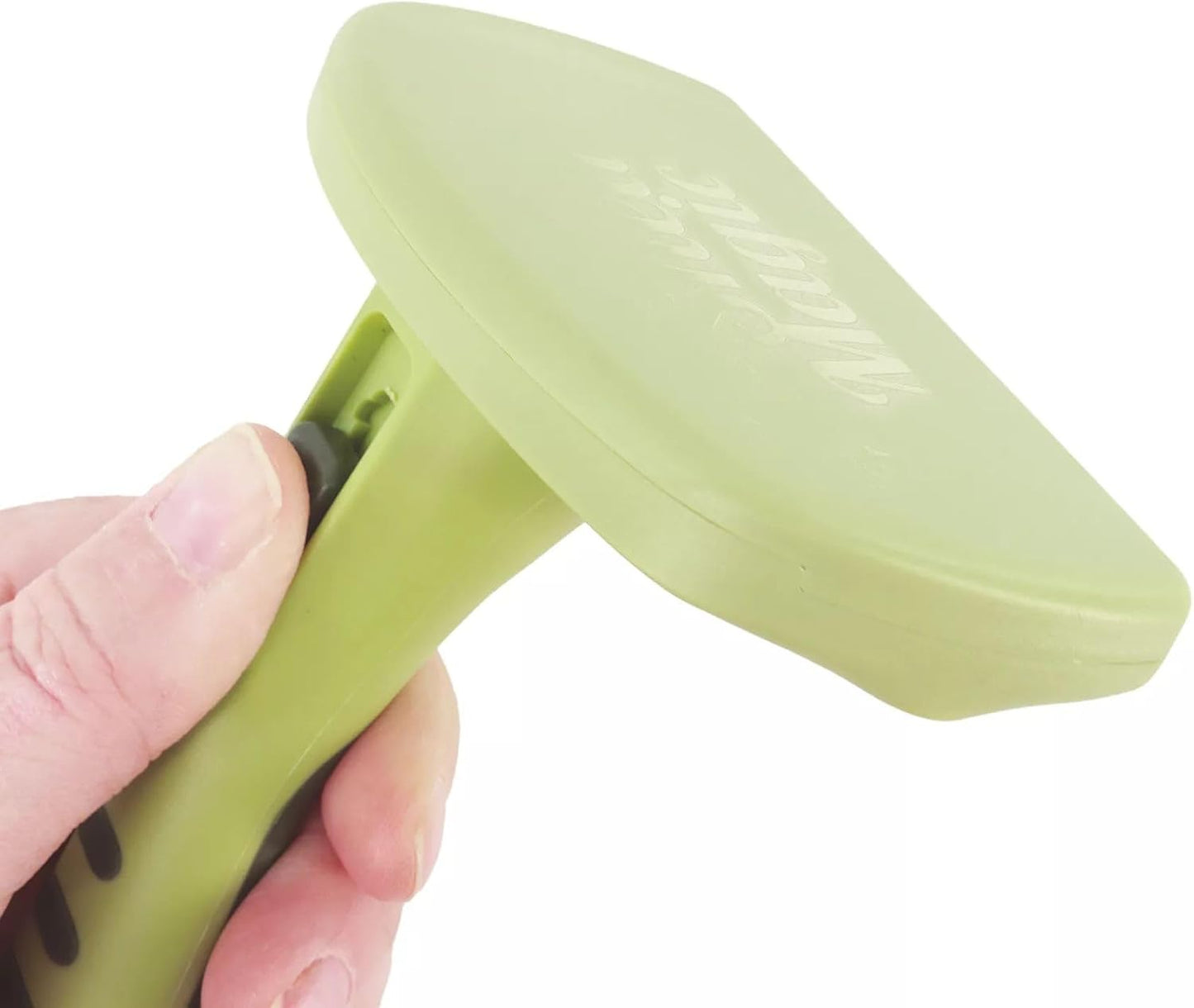 Hand holding Safari self-cleaning cat brush for grooming