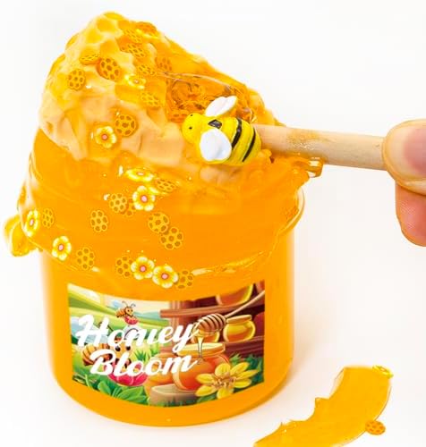 Fluffy textured yellow slime mixed with faux bee sprinkles being stretched for ASMR play