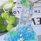 Close up view of the collectible miniature turtle toy charm inside the transparent blue beaded slime.