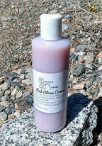8 Fluid Ounce bottle of Mommy's Miracles Red Alaea Hawaiian Ormus Monoatomic Gold Manna on display
