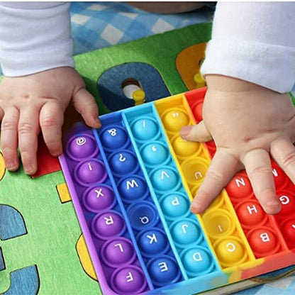 Child practicing spelling and counting with silicone alphabet learning tool