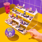 Unboxed miniature replica components of Crunchwrap Supreme and Mexican Pizza with tiny sauce packets.