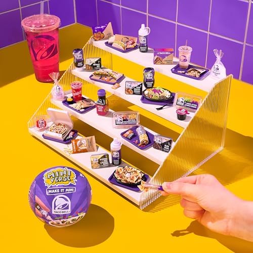 Unboxed miniature replica components of Crunchwrap Supreme and Mexican Pizza with tiny sauce packets.