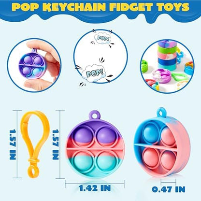 Assorted multicolor mini popping toys with plastic clasps spread out across a table.