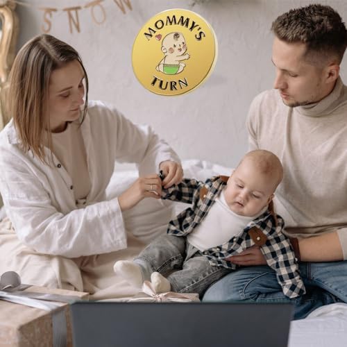 Vichona first time dad and mom keepsake coin resting on a flat nursery table.