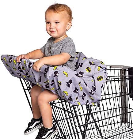 Toddler sitting comfortably inside the padded J.L. Childress Batman cover attached to a restaurant high chair.