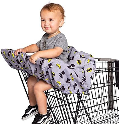 Toddler sitting comfortably inside the padded J.L. Childress Batman cover attached to a restaurant high chair.