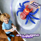 Wireless remote control handset being used to guide the blue and red wall climbing robot toy