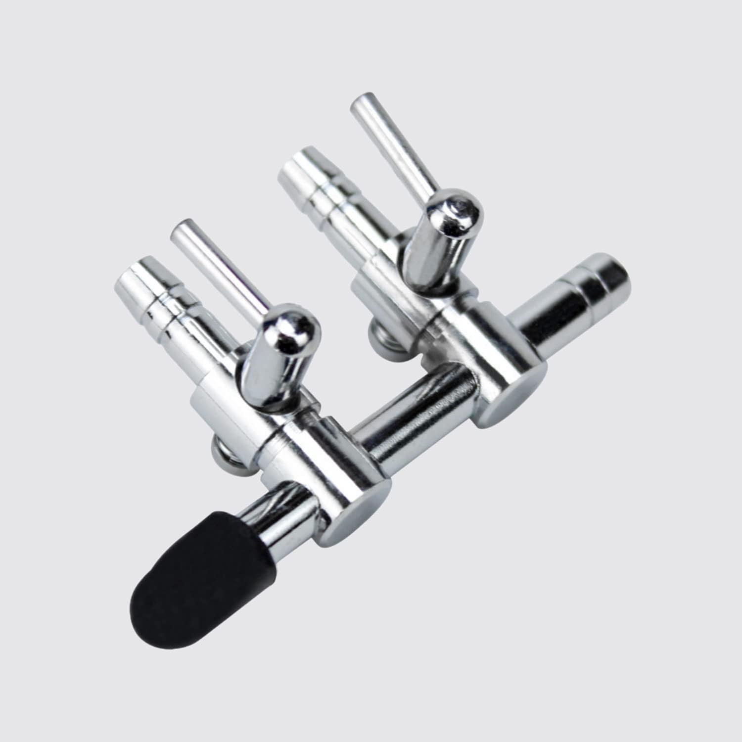 Close-up of the adjustable chrome copper levers on the aquarium air flow control manifold.