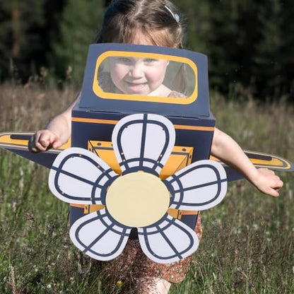 Toddler playing with blue Safigle cardboard plane costume in backyard
