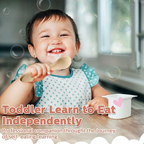 Nuenen infant silicone training spoon and fork pair being held by a toddler for self feeding practice